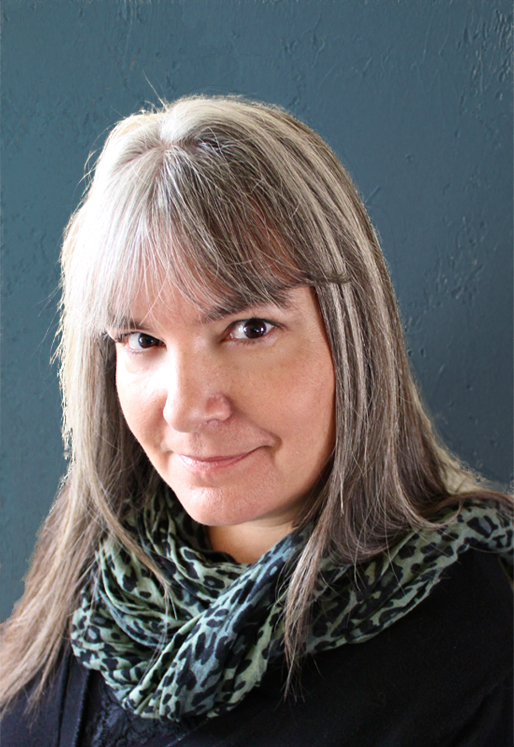 Professional headshot of Jennifer Lawler, woman with medium legth brown hair wearing a scarf. 